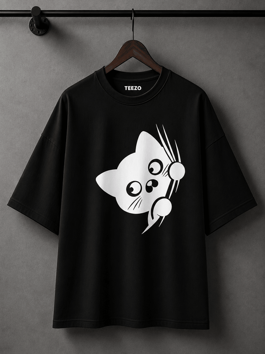 Cream oversized cotton T-shirt featuring a cute black peekaboo cat graphic for unisex streetwear.