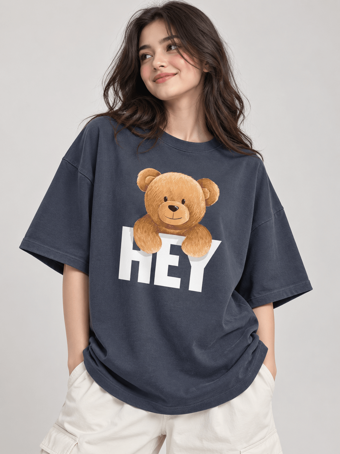 Female model wearing dark blueish grey HEY teddy bear oversized drop shoulder T-shirt