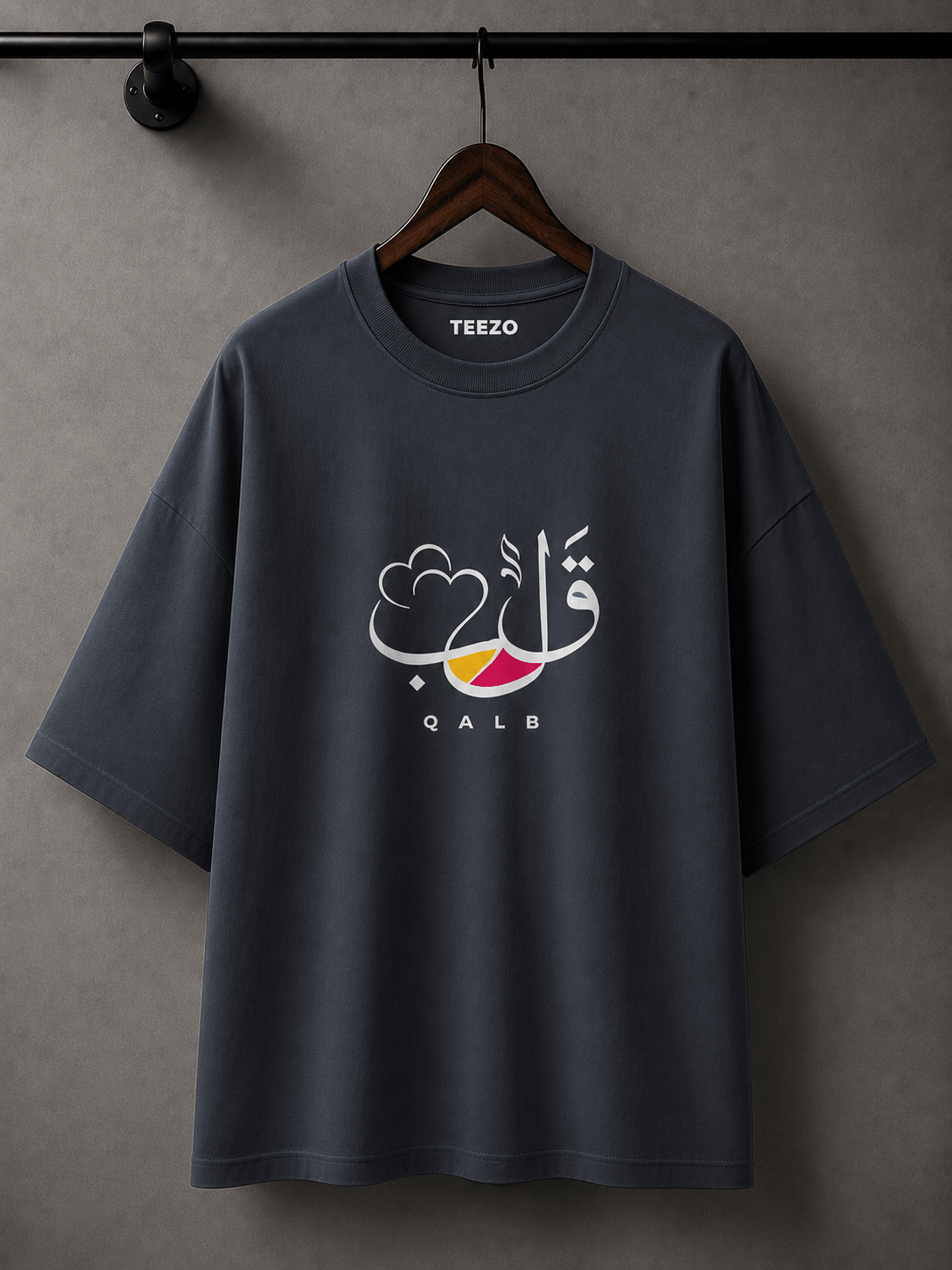 White oversized cotton T-shirt featuring elegant QALB Arabic calligraphy graphic for unisex streetwear.