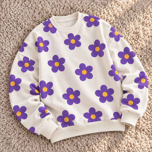 Off-white sweatshirt featuring purple floral prints with yellow centers by TEEZO