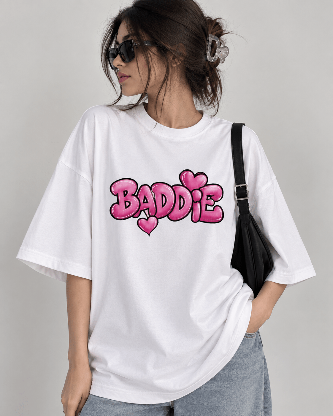 White oversized BADDIE graphic T-shirt with pink bubble lettering