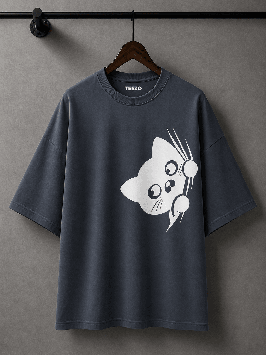 Cream oversized cotton T-shirt featuring a cute black peekaboo cat graphic for unisex streetwear.