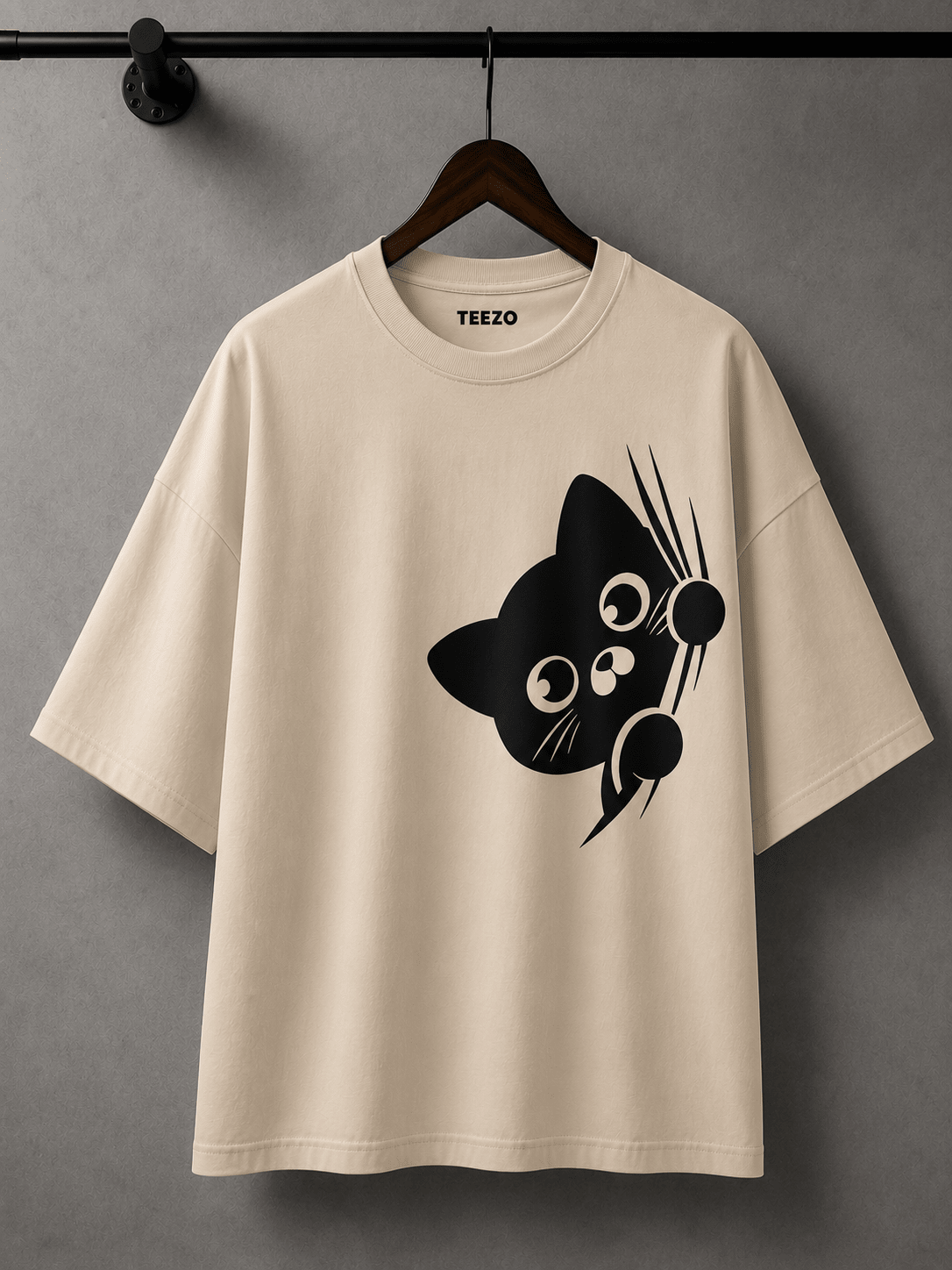Cream oversized cotton T-shirt featuring a cute black peekaboo cat graphic for unisex streetwear.