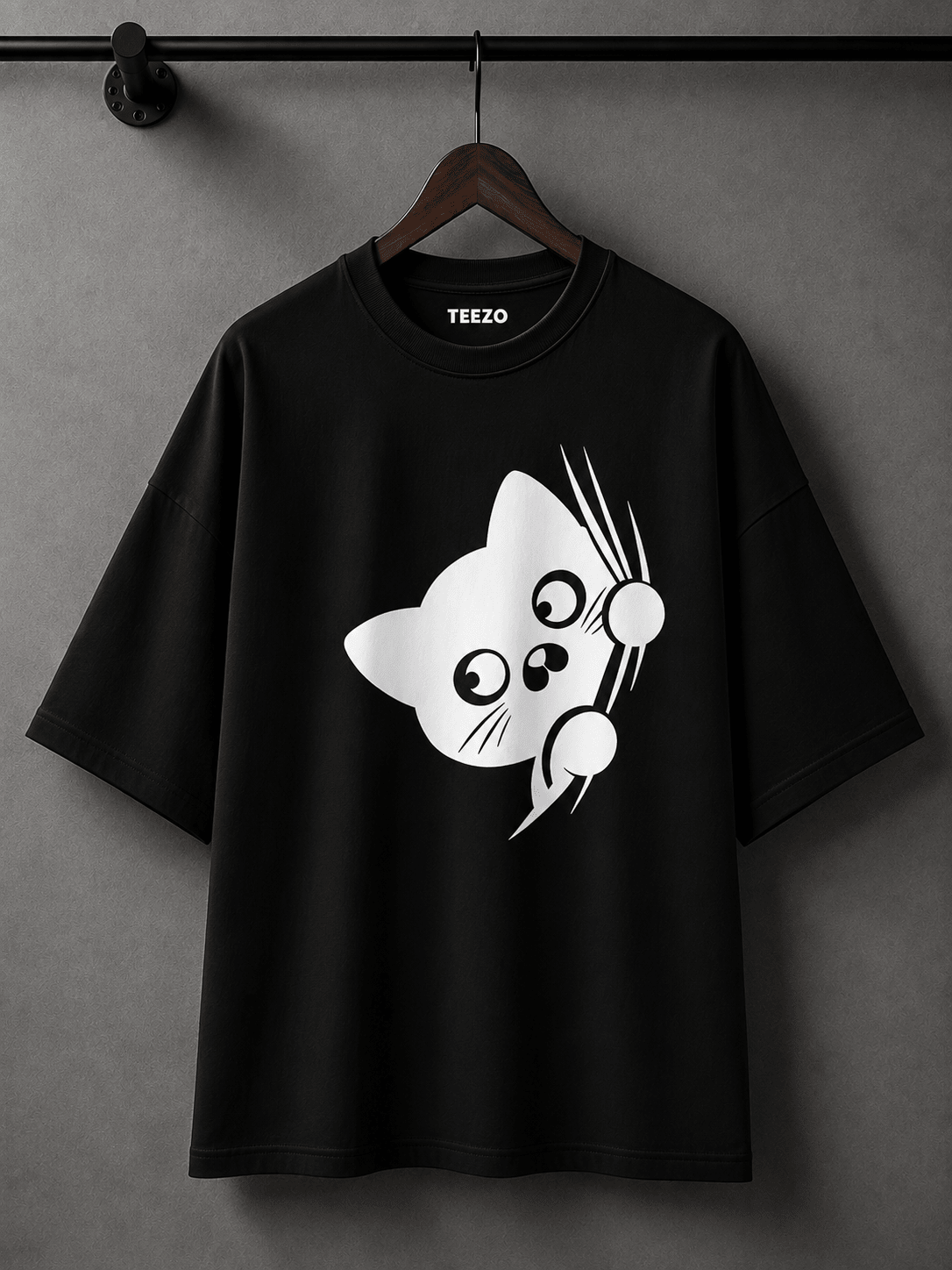 Cream oversized cotton T-shirt featuring a cute black peekaboo cat graphic for unisex streetwear.