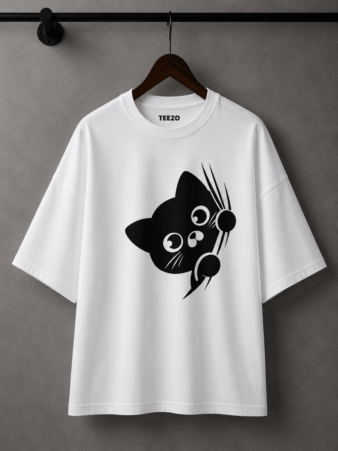 Cream oversized cotton T-shirt featuring a cute black peekaboo cat graphic for unisex streetwear.