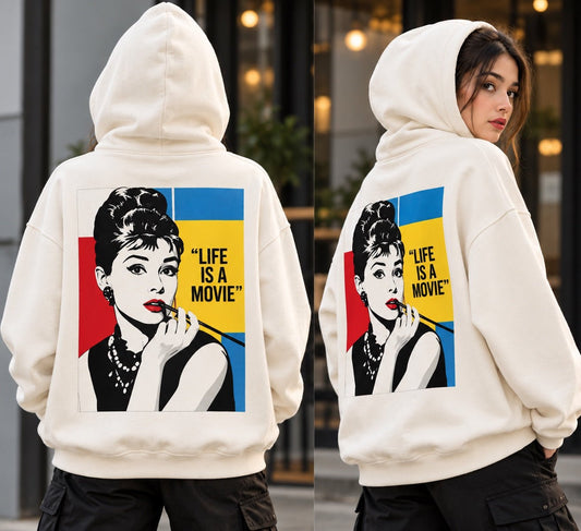Female model wearing TEEZO Life Is A Movie graphic hoodie from back