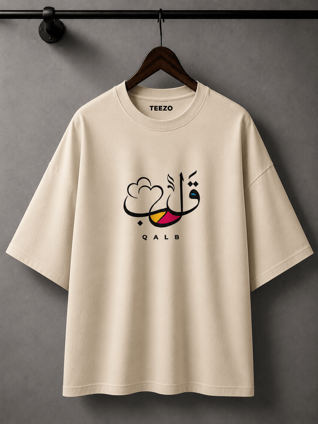 White oversized cotton T-shirt featuring elegant QALB Arabic calligraphy graphic for unisex streetwear.