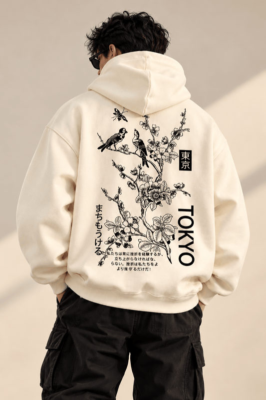 TEEZO Tokyo Sakura off white oversized hoodie featuring black Japanese floral artwork, birds and Tokyo graphic print on the back, styled on a male model.