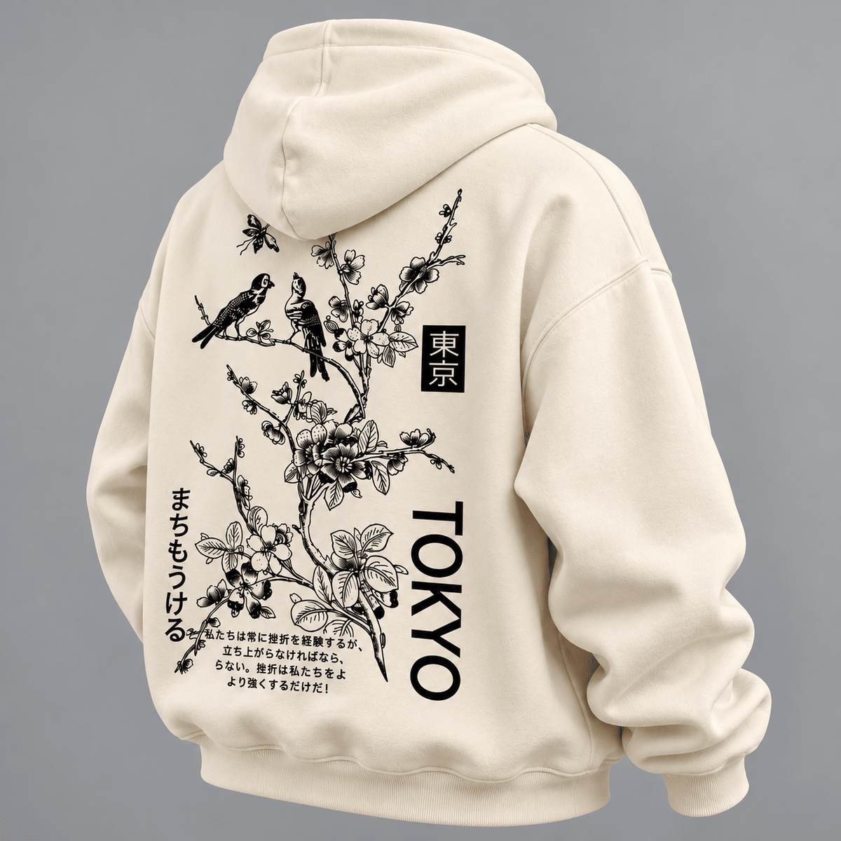 TEEZO Tokyo Sakura off white oversized hoodie featuring black Japanese floral artwork, birds and Tokyo graphic print on the back, styled on a male model.
